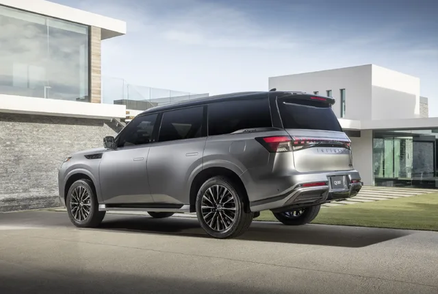 2025 Infiniti QX80 rear three-quarter view at modern home