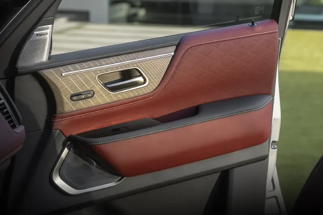 2025 Infiniti QX80 front door panel with Klipsch speaker and quilted leather