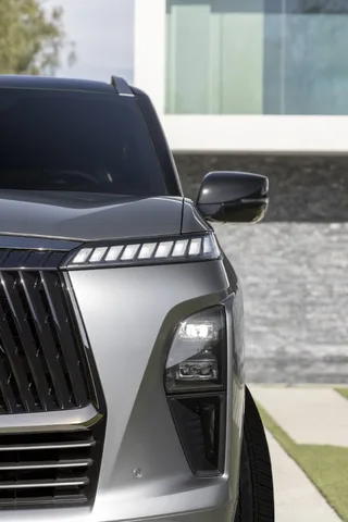 2025 Infiniti QX80 front headlight and grille corner detail