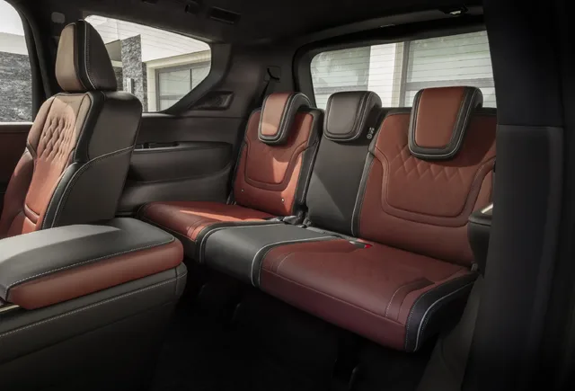 2025 Infiniti QX80 second and third row seating in burgundy