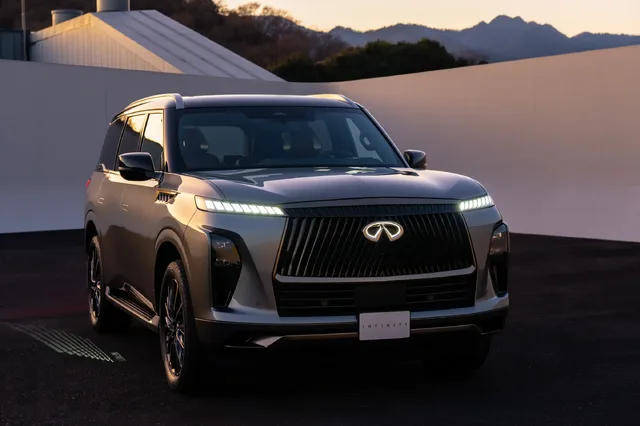 2025 Infiniti QX80 front three-quarter view at dusk
