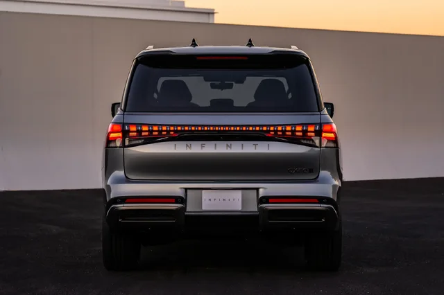 2025 Infiniti QX80 rear view at dusk with taillights on