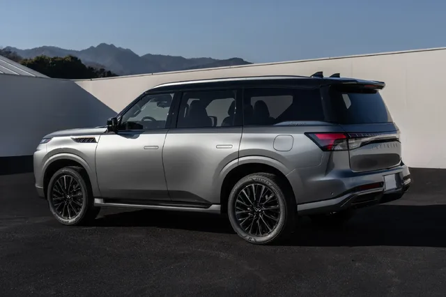 2025 Infiniti QX80 passenger rear three-quarter view in silver