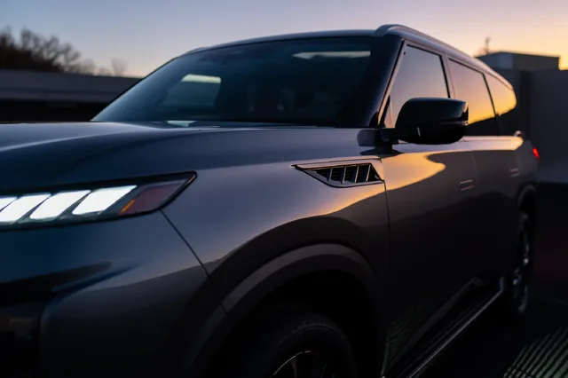 2025 Infiniti QX80 front quarter detail at sunset
