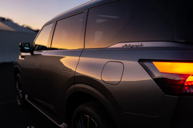 2025 Infiniti QX80 Autograph rear quarter detail at sunset