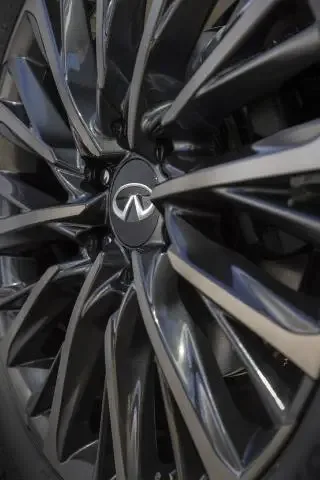 2025 Infiniti QX80 dark-finished multi-spoke wheel close-up