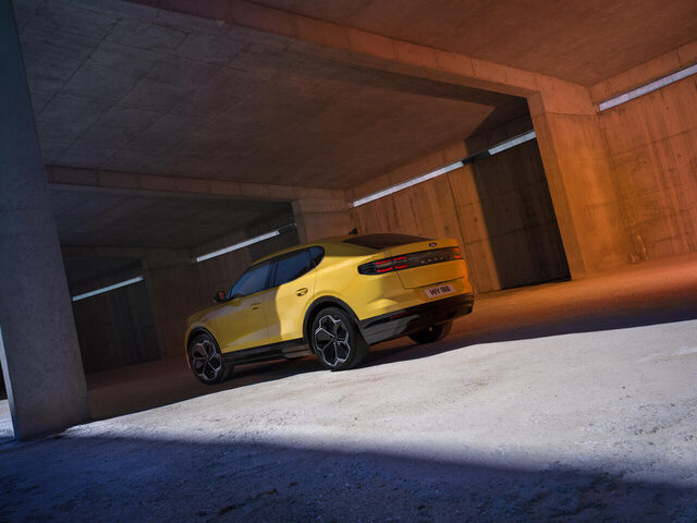 2024 Ford Capri rear three-quarter in Vivid Yellow in parking garage