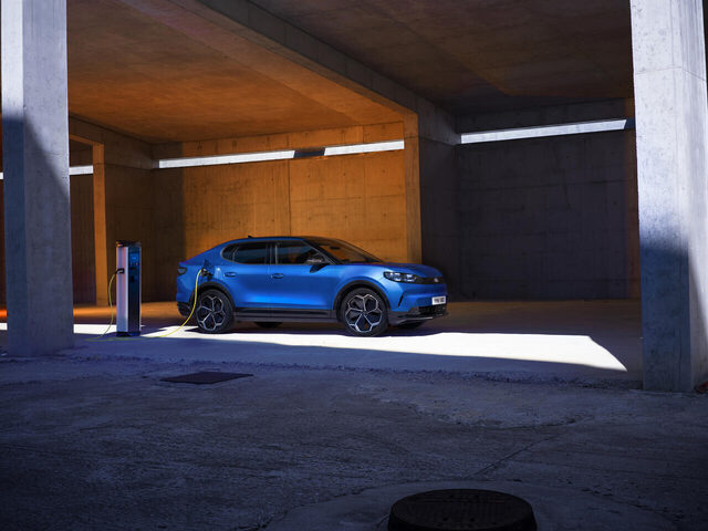 2024 Ford Capri in Blue charging in a concrete parking structure