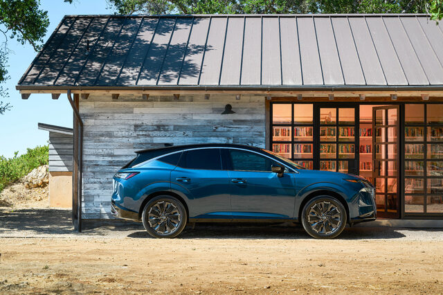 2025 Nissan Murano passenger side profile parked by rustic building