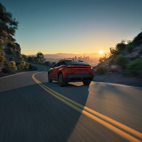 2026 Toyota C-HR Rear Three-Quarter View Driving at Sunset