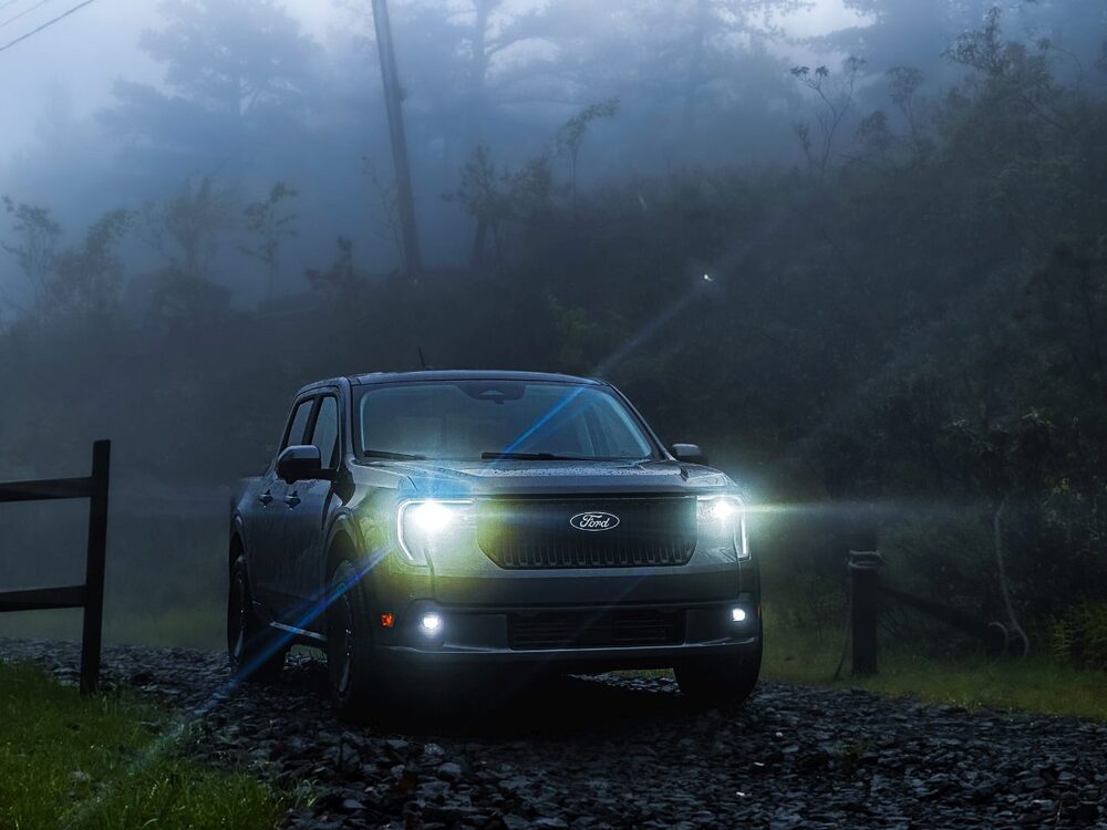 2025 Ford Maverick Lobo - Front Side in Fog on a gravel road with headlights on