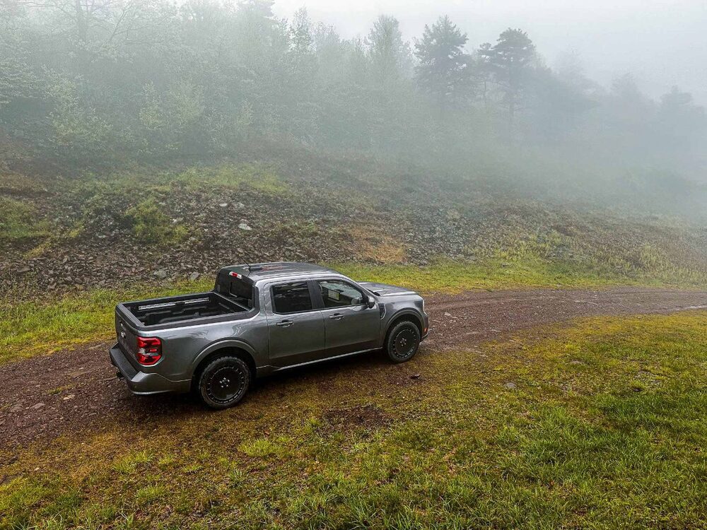 2025 Ford Maverick Lobo from the side above on a dirt road in the fog
