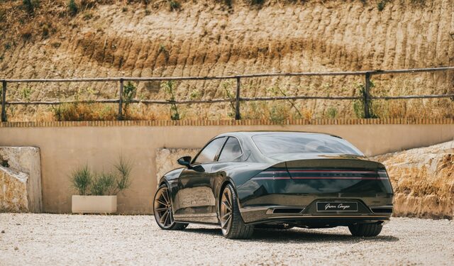 Genesis X Gran Coupe Concept Rear Three-Quarter View on Gravel Courtyard