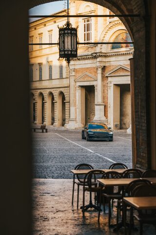 Genesis X Gran Coupe Concept Viewed Through Italian Piazza Archway