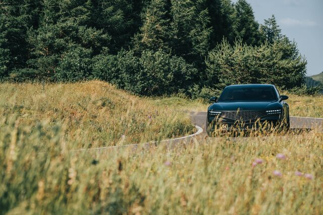 Genesis X Gran Coupe Concept Approaching on Winding Country Road Through Meadow