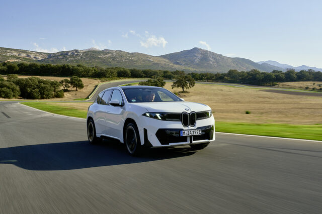 2026 BMW iX3 Front Three-Quarter View on Track with Mountain Backdrop
