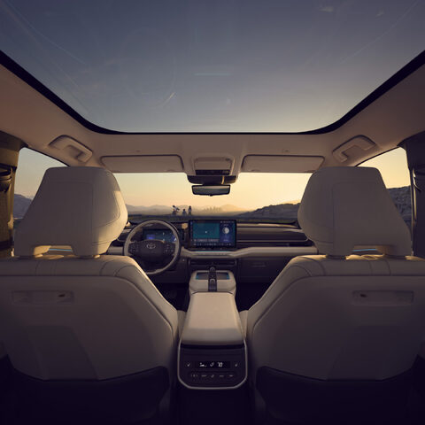 2027 Toyota Highlander EV Interior View from Rear Seat at Sunset