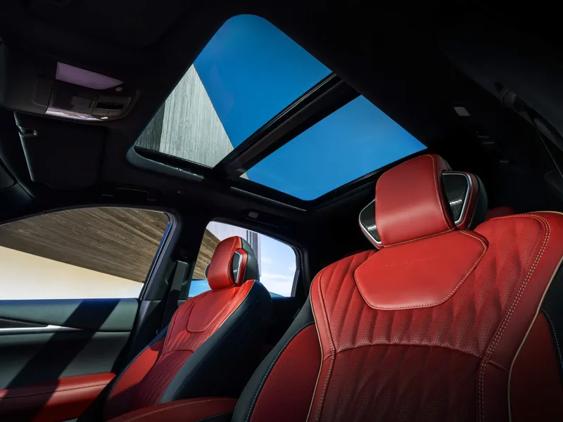 2027 Infiniti QX65 Interior Rear Cabin View Showing Panoramic Sunroof Open and Red Leather Front Seats