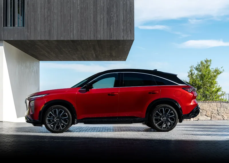 2027 Infiniti QX65 Sport Exterior Side Profile Sunfire Red with Black Roof Showing Fastback Roofline