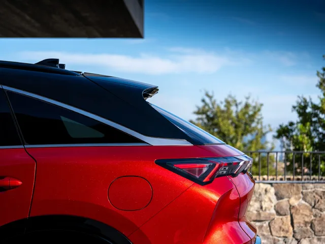 2027 Infiniti QX65 Sport Exterior Rear Quarter Closeup Showing Fastback Roofline Spoiler and LED Taillights Sunfire Red