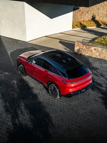 2027 Infiniti QX65 Sport Exterior Elevated Rear View Showing Panoramic Roof and Fastback Roofline Sunfire Red