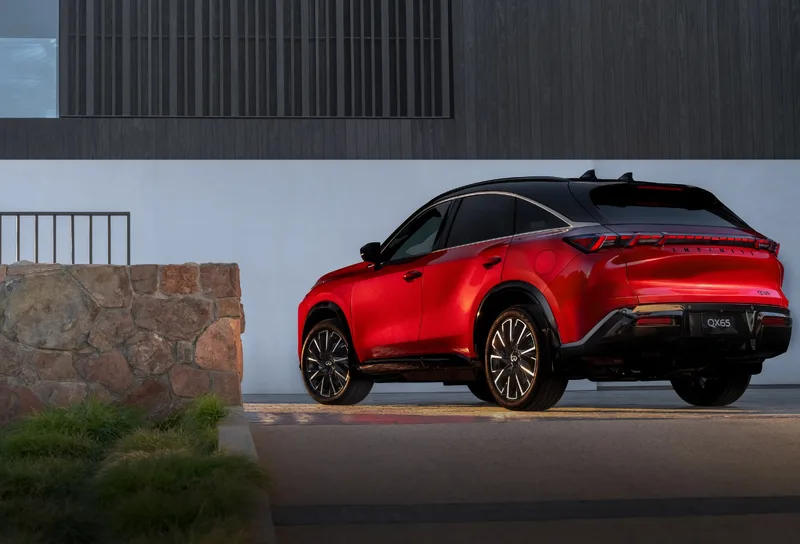 2027 Infiniti QX65 Autograph Exterior Rear Three-Quarter View Sunfire Red with Polished Multi-Spoke Wheels
