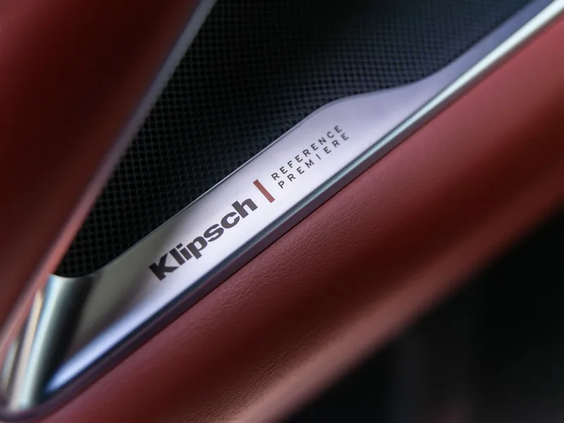 2027 Infiniti QX65 Autograph Interior Klipsch Reference Premiere Speaker Badge Closeup Red Leather