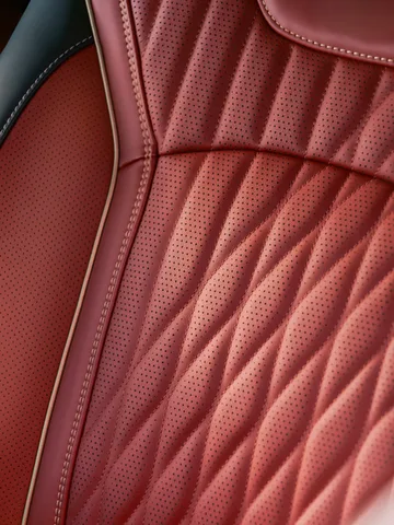 2027 Infiniti QX65 Interior Perforated Red Leather Seat Closeup with Diamond Quilting Pattern