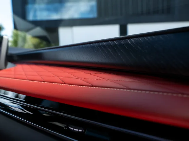 2027 Infiniti QX65 Interior Dashboard Top Edge Showing Red Quilted Leather and Dark Textured Trim