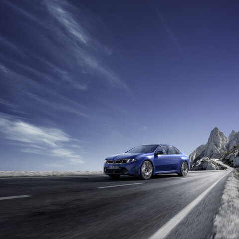 2027 BMW i3 Sedan Front Three-Quarter on Open Highway