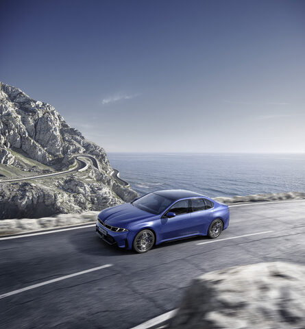 2027 BMW i3 Sedan High-Angle Front Three-Quarter on Coastal Road
