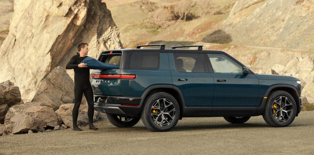 2027 Rivian R2 Rear Three-Quarter with Roof Rack at Beach