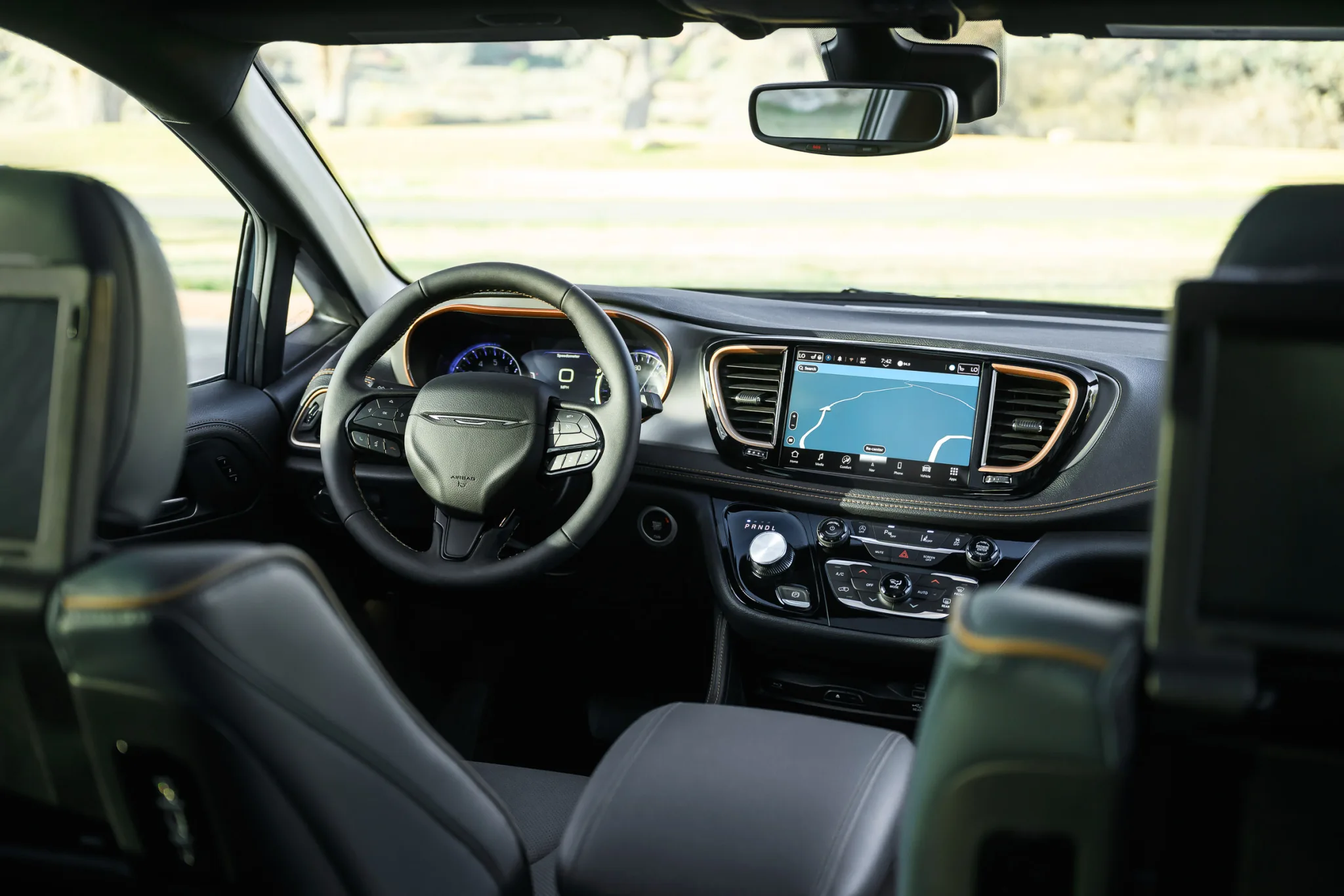 2027 Chrysler Pacifica Pinnacle interior with Chrysler wing badge steering wheel and Uconnect 10.1-inch touchscreen with Copper Alloy bezels