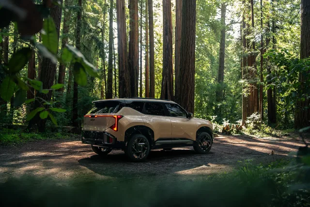 2027 Kia Seltos X-Line Sandy Gold Rear Three-Quarter in Redwood Forest